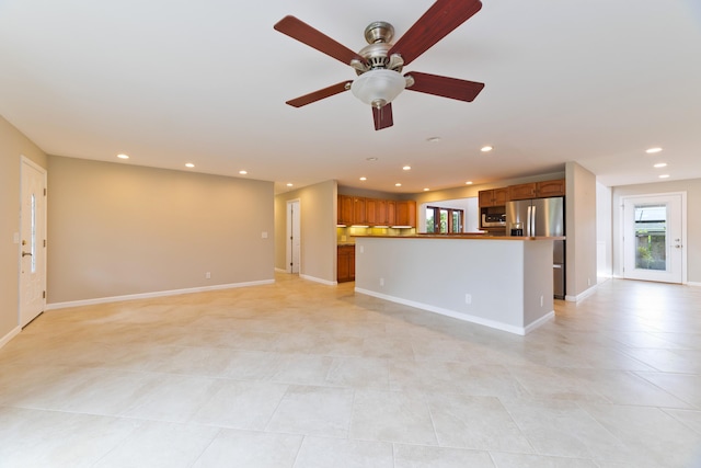 unfurnished living room with ceiling fan