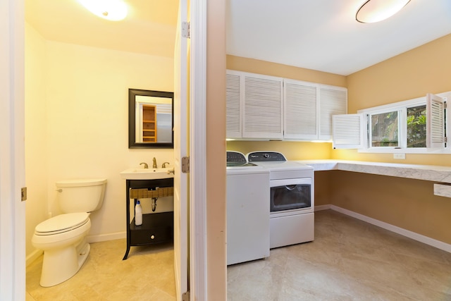 washroom with separate washer and dryer and sink