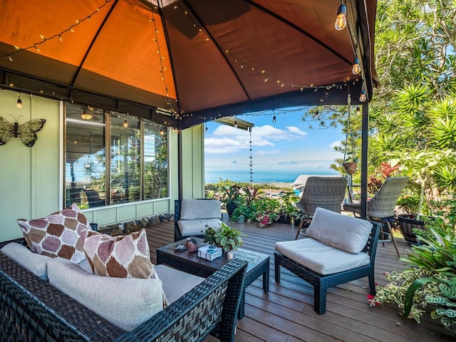 wooden deck featuring a gazebo and outdoor lounge area