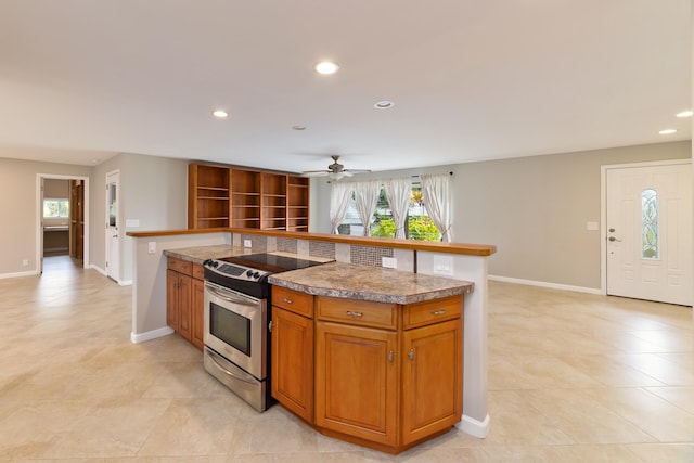 kitchen featuring stainless steel electric stove and ceiling fan