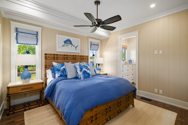 bedroom featuring crown molding, dark wood-type flooring, and ceiling fan