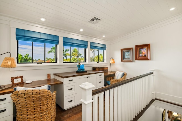 interior space featuring wood ceiling, ornamental molding, and dark hardwood / wood-style floors