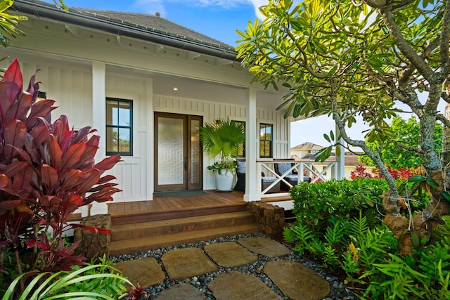 view of exterior entry with covered porch