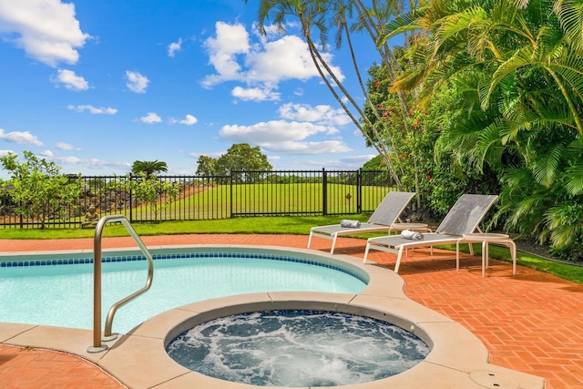 view of swimming pool with an in ground hot tub, a yard, and a patio