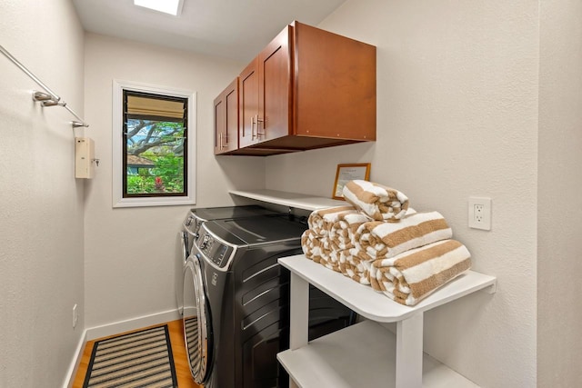 washroom with washing machine and dryer and cabinets