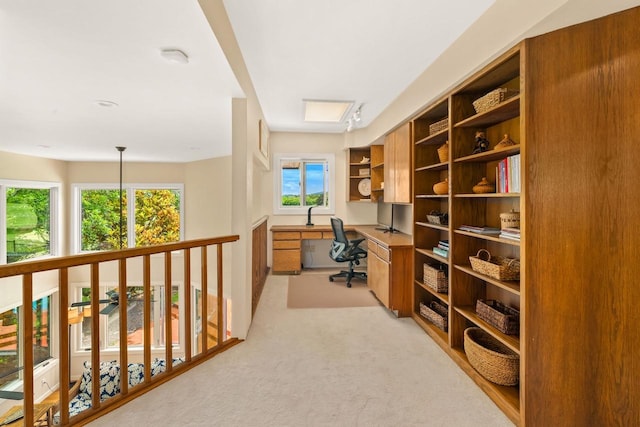 carpeted home office with built in desk