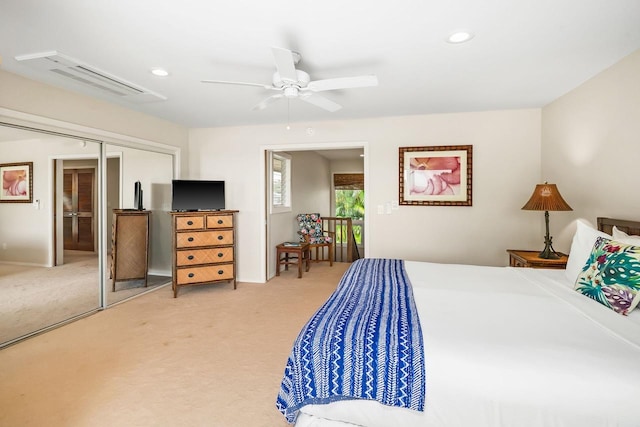 carpeted bedroom featuring ceiling fan and a closet