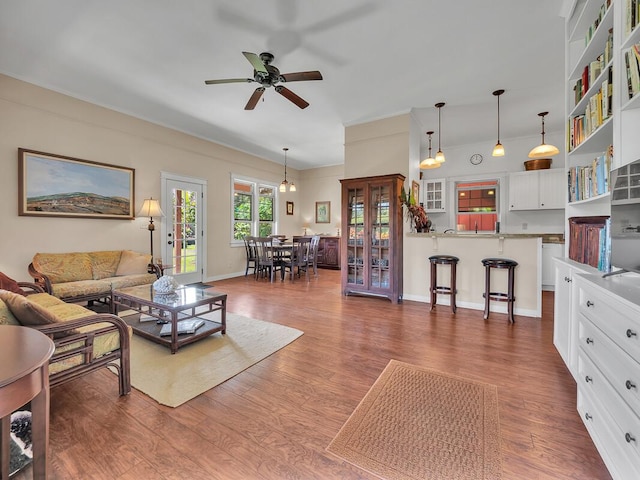 living room featuring dark wood-type flooring and ceiling fan