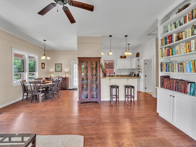 living room featuring dark wood-type flooring and ceiling fan