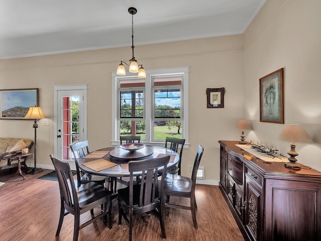 dining space featuring hardwood / wood-style floors and crown molding