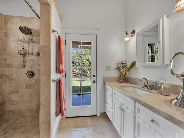 bathroom featuring vanity and tiled shower