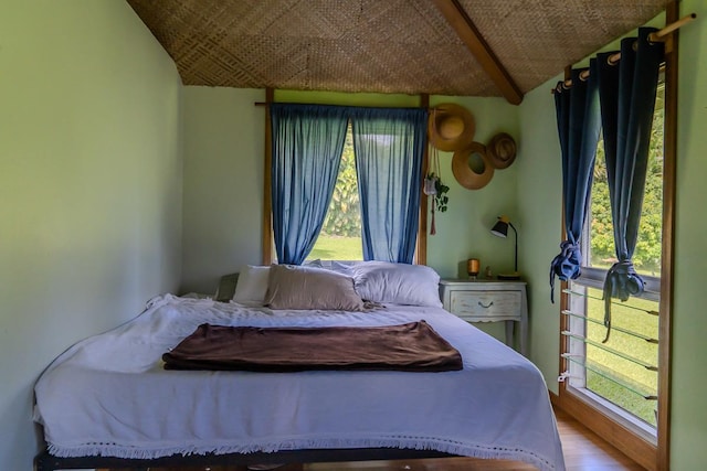 bedroom featuring hardwood / wood-style floors and lofted ceiling