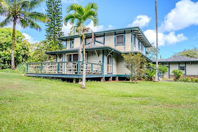 rear view of property with a lawn