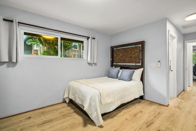 bedroom with light hardwood / wood-style floors