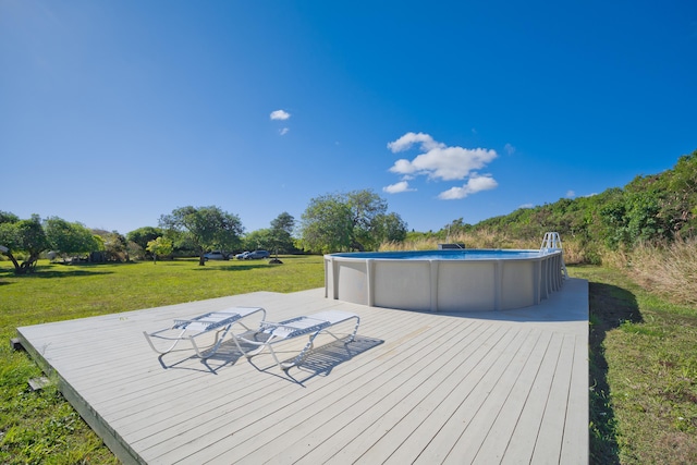 wooden deck featuring a yard