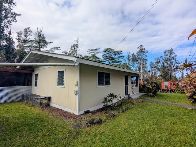 exterior space featuring a yard and a carport