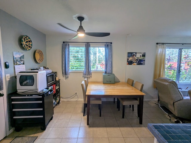 tiled dining room featuring ceiling fan