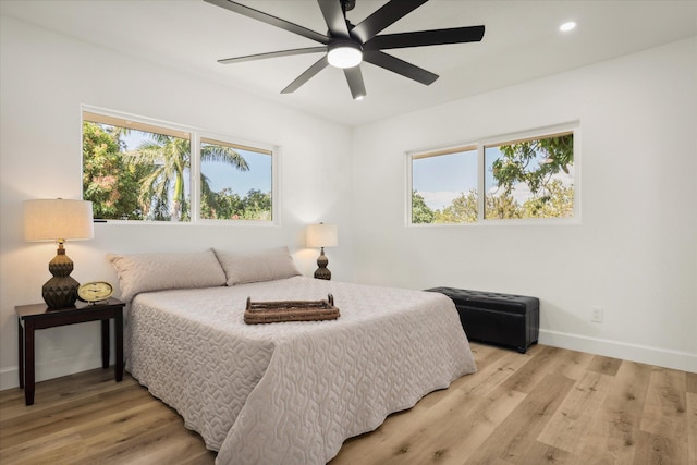 bedroom featuring ceiling fan and light hardwood / wood-style flooring