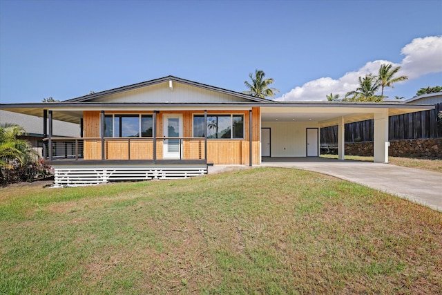 view of front of house with a carport, a porch, and a front yard