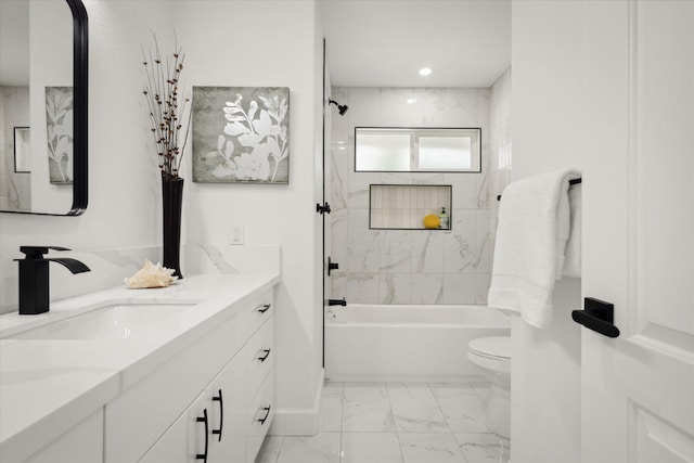 full bathroom with vanity, toilet, and tiled shower / bath combo