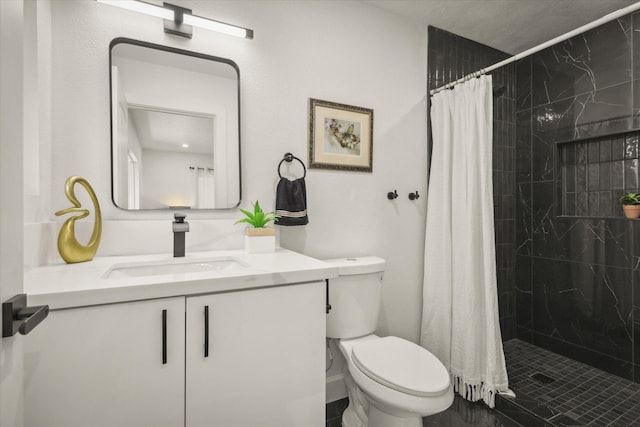 bathroom featuring vanity, toilet, and curtained shower