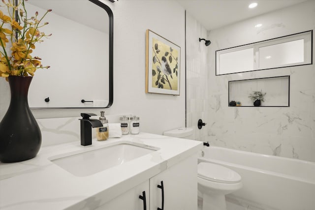 full bathroom with vanity, toilet, and tiled shower / bath combo