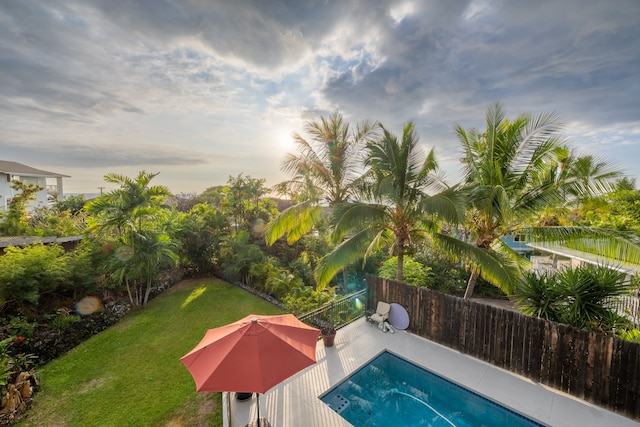 pool at dusk with a lawn