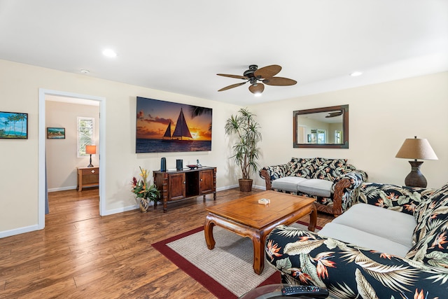 living room featuring dark hardwood / wood-style floors and ceiling fan