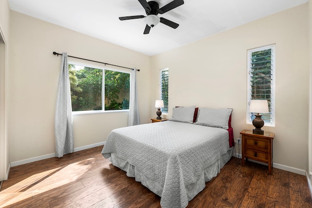 bedroom with dark hardwood / wood-style flooring and ceiling fan