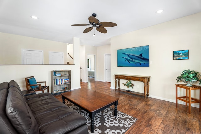 living room featuring ceiling fan and dark hardwood / wood-style floors