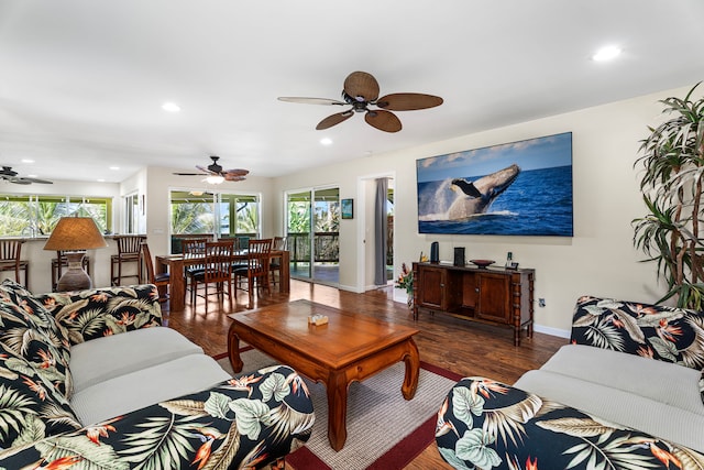 living room with dark hardwood / wood-style floors and ceiling fan