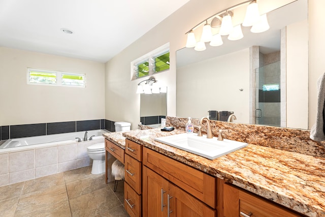 full bathroom with vanity, toilet, and separate shower and tub