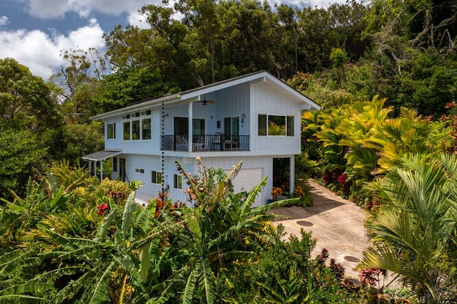 view of front of house featuring a garage and a balcony