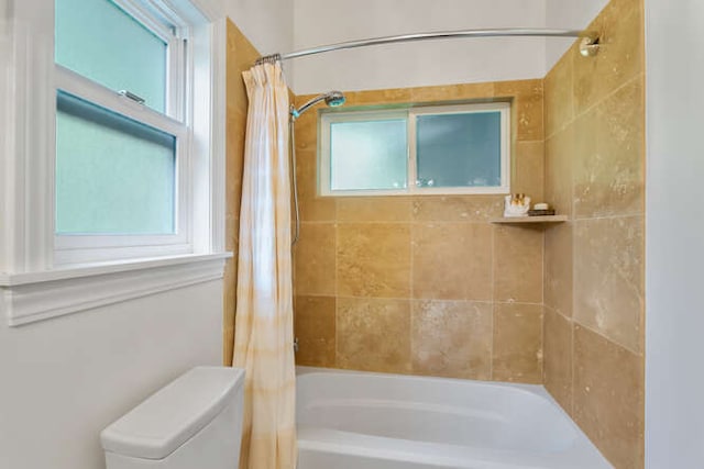 bathroom featuring toilet and shower / bath combo with shower curtain