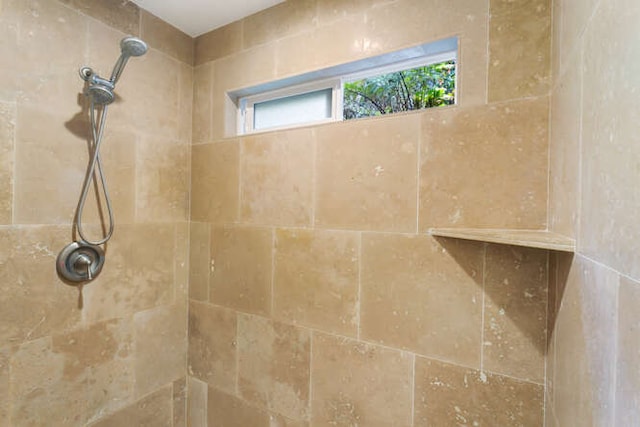 bathroom with a tile shower