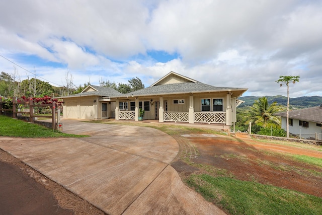 view of front of home with a porch and a garage