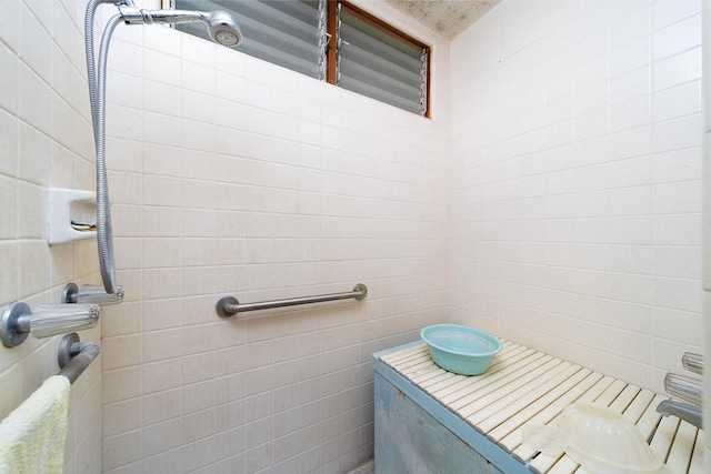 bathroom with tile walls