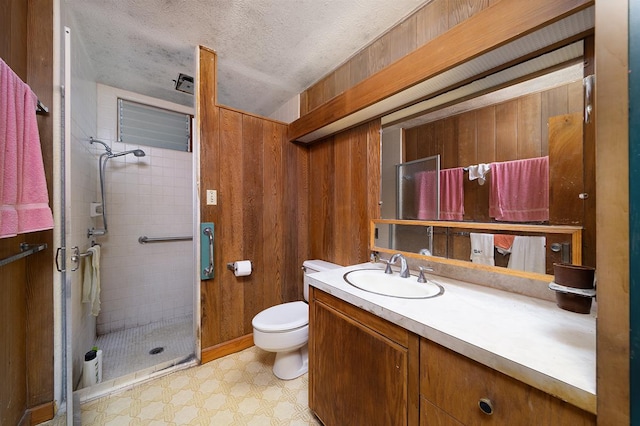 bathroom featuring vanity, wooden walls, and a tile shower