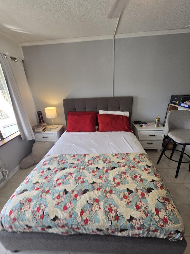 tiled bedroom featuring crown molding and a textured ceiling