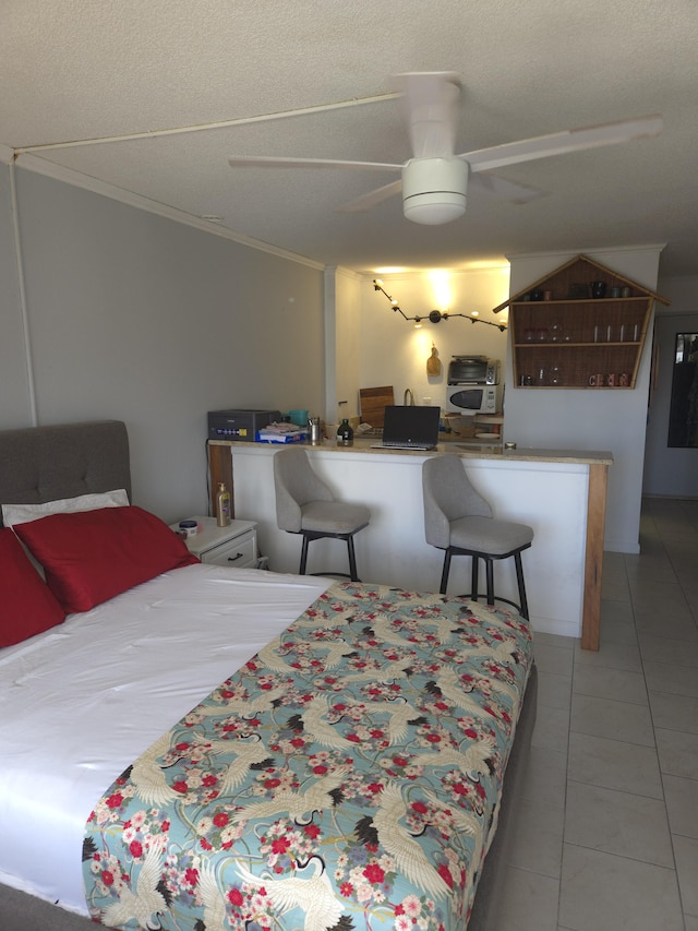 bedroom with crown molding, light tile patterned flooring, and ceiling fan