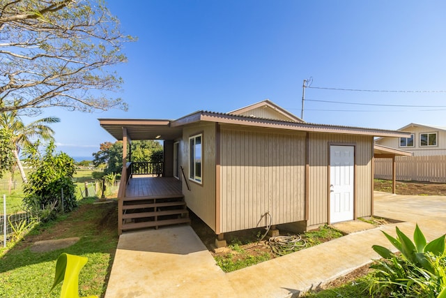 view of side of property featuring a wooden deck