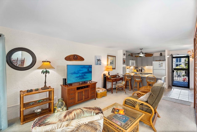 carpeted living room featuring ceiling fan