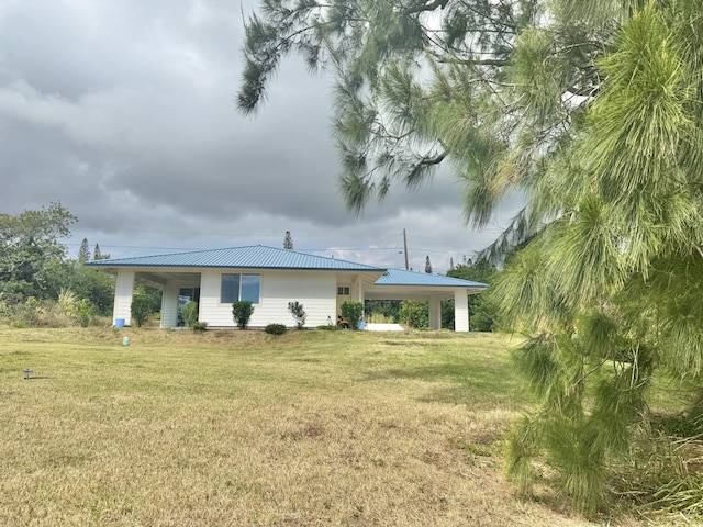 exterior space with a yard and a carport