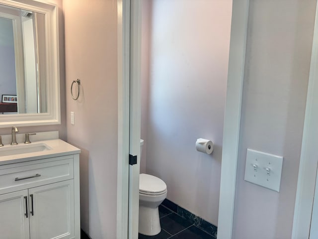 bathroom featuring tile patterned floors, toilet, and vanity