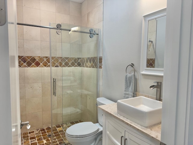 bathroom with vanity, walk in shower, and toilet