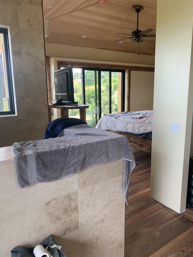 bedroom featuring ceiling fan, dark hardwood / wood-style floors, and wood ceiling