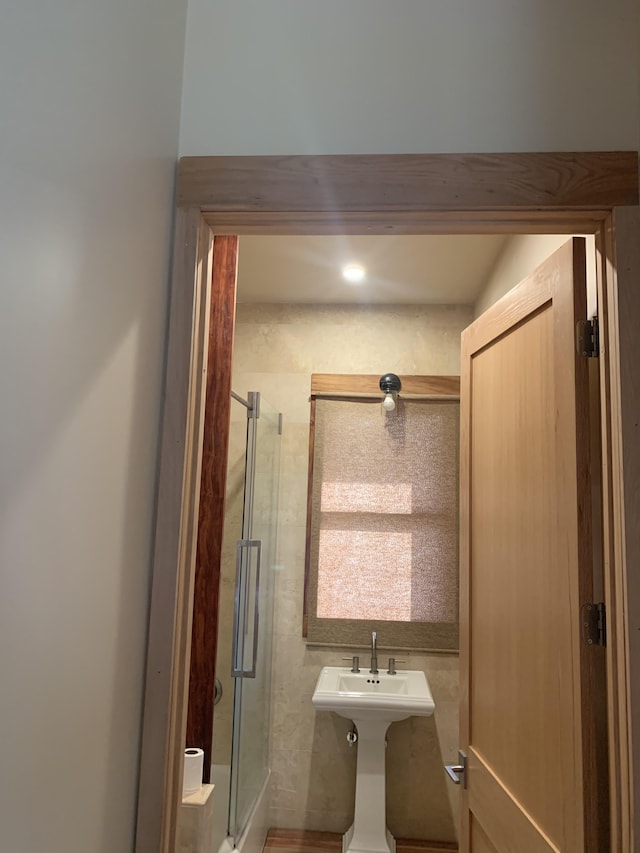 bathroom featuring a shower with door