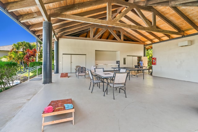 view of patio / terrace featuring outdoor dining space, a wall mounted air conditioner, and a gazebo