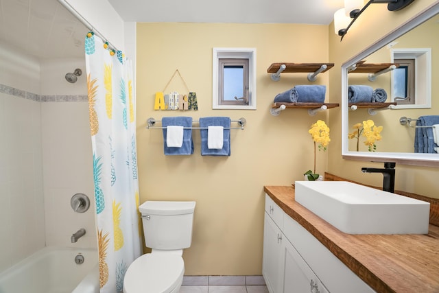 bathroom with tile patterned flooring, shower / bath combo, vanity, and toilet