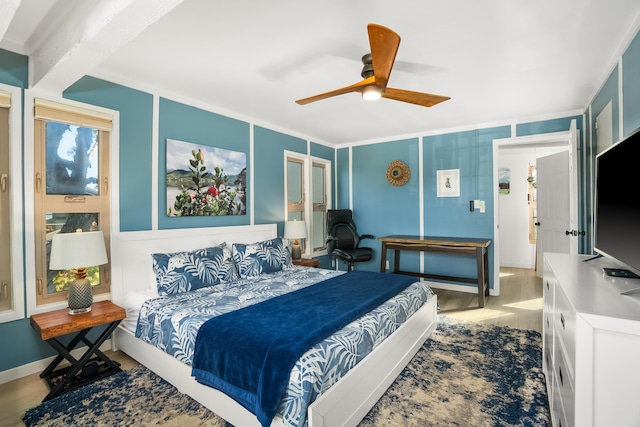 bedroom with ceiling fan, ornamental molding, wood finished floors, and baseboards